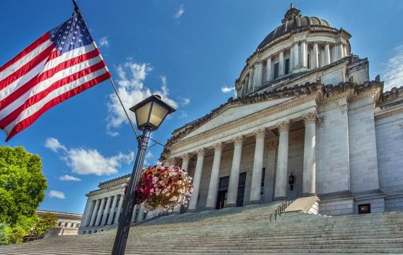 A flag blows in the wind outside the Washington state capitol building where Gov. Ferguson just signed the Parents Rights bill