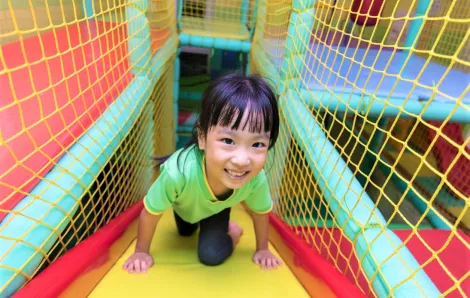 girl playing in indoor play gym
